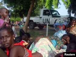 FILE - A U.N. truck drives past displaced South Sudanese families resting in a camp for internally displaced people in the United Nations Mission in South Sudan (UNMISS) compound in Tomping, Juba, July 11, 2016.