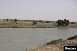 FILE - A view of the Euphrates River from al-Bugilia, north of Deir el-Zour, Syria, Sept. 21, 2017.