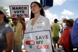 Medical student Rebecca Tanenbaum protests agains the current GOP health care bill outside of the office of Sen. Marco Rubio, R-Fla., June 28, 2017, in Miami.