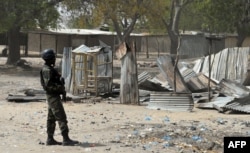 FILE - A Cameroonian soldier walks in the Cameroonian town of Fotokol, on the border with Nigeria, on Feb. 17, 2015, after clashes occurred Feb. 4 between Cameroonian troops and Nigeria-based Boko Haram insurgents.