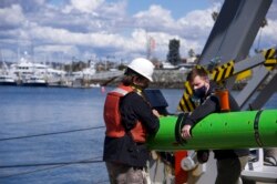 In this March 2021 image provided by Scripps Institution of Oceanography at UC San Diego, researchers aboard the research vessel Sally Ride recover a robtic underwater vehicle off the coast of Southern California. (Scripps Institution of Oceanography at UC San Diego via AP)