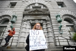Beth Kohn protests against U.S. President Donald Trump's executive order outside the 9th U.S. Circuit Court of Appeals courthouse in San Francisco, California, Feb. 7, 2017.