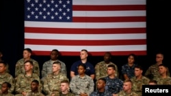 Military personnel watch as U.S. President Donald Trump announces his strategy for the war in Afghanistan during an address to the nation from Fort Myer, Virginia, Aug. 21, 2017.