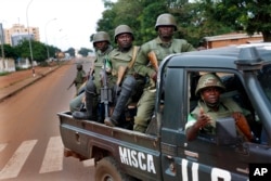 FILE - African Union MISCA troops from Cameroon patrol in Bangui, Central African Republic, May 29, 2014.