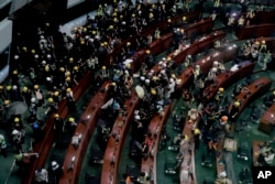 Protesters gather inside the meeting hall of the Legislative Council in Hong Kong, Monday, July 1, 2019.