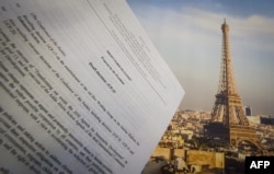 An illustration picture taken on Dec. 10, 2015 in Paris shows a draft for the outcome of the COP21 United Nations conference on climate change next to a picture of the Eiffel Tower. Trump has promised to withdraw from the agreement.