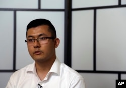 Kamalturk Yalqun speaks about his imprisoned father, Yalqun Rozi, Thursday, April 18, 2019, in Philadelphia. (AP Photo/Jacqueline Larma)