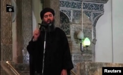 FILE - This image taken from video shows man purported to be Abu Bakr al-Baghdadi, ISIL's reclusive leader, making what would be his first public appearance at a mosque in the centre of Iraq's second city, Mosul, July 5, 2014.