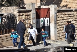 Schoolchildren evacuate a school after shelling by Syrian rebels on government-held western Aleppo, Syria, in this handout picture provided by SANA on Nov. 20, 2016.