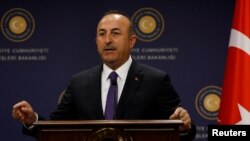 FILE - Turkish Foreign Minister Mevlut Cavusoglu gestures during a news conference in Ankara, Turkey, April 16, 2018.