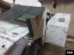 This armored car was about to explode with a suicide bomber inside when the militant driving rode into a ditch and was shot by Iraqi forces in Hammam Alil, Iraq, April 3, 2017. (H. Murdock/VOA)