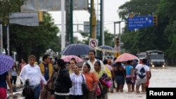 Stranded tourists salvaged belongings from submerged cars in the Mexican beach resort of Acapulco which had become a floodplain on Tuesday, Sept. 17, 2013.