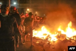 Indonesian protesters burn wooden stalls during a demonstration near by the Elections Oversight Body in Jakarta, Indonesia, May 22, 2019.