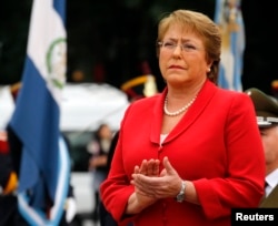 FILE - Chile's President Michelle Bachelet applauds as she attends a wreath-laying ceremony in Buenos Aires, May 12, 2014.