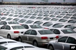 FILE - Volkswagen Jettas produced in Mexico for export are parked at the port terminal in the Gulf city of Veracruz, Mexico.