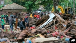 Residents inspect a house damaged by a tsunami, in Carita, Indonesia, Dec. 23, 2018.