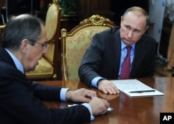 FILE - Russian President Vladimir Putin, right, listens to Russian Foreign Minister Sergey Lavrov during their meeting in the Kremlin in Moscow, Russia, March 14, 2016.