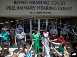 Nadine Collier, left, the daughter of Ethel Lance, one of the nine people killed in Wednesday's shooting at Emanuel AME Church, speaks to the media about her mother following the bond hearing for the suspected gunman, in North Charleston, S.C., June 19, 2