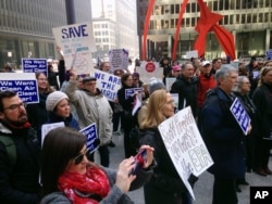 FILE - Environmental Protection Agency employees and environmental activists gather in Chicago, Feb. 6, 2017, to protest the nomination of Scott Pruitt for administrator of the agency.