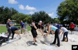 City of Miami volunteers help residents fill free sandbags as residents prepare for Hurricane Irma, Sept. 7, 2017.