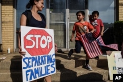 People participate in a protest against recent U.S. immigration policy that separates children from their families when they enter the U.S. as undocumented immigrants, in front of a Homeland Security facility in Elizabeth, New Jersey, June 17, 2018.