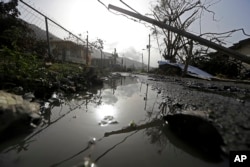 Downed power lines and debris are seen in the aftermath of Hurricane Maria in Yabucoa, Puerto Rico, Sept. 26, 2017.