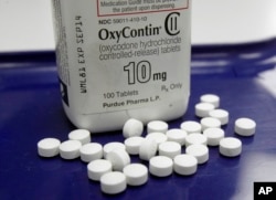 FILE - OxyContin pills, an opioid drug, are arranged for a photo at a pharmacy in Montpelier, Vermont, Feb. 19, 2013. An estimated 91 people die each day in the U.S. from opioid-related addictions.