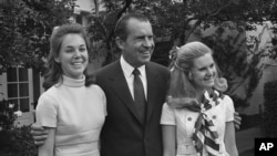 FILE - Richard Nixon with daughters