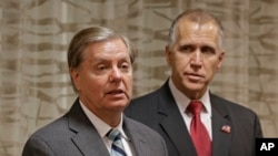 Sen. Lindsey Graham (R-SC), left, speaks to the media about national security as North Carolina Republican Sen. Thom Tillis, right, listens, in Greensboro, N.C., Sept. 26, 2014.