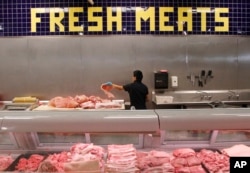 FILE - Researchers found a correlation between risk of heart disease and the saturated fat found in meats, cheeses, and palm and coconut oils.