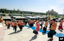 FILE - Lawmakers of the National League for Democracy party (NLD), leave the parliament after attending a regular session of the Union Parliament in Naypyitaw, Myanmar, Jan. 24, 2018.