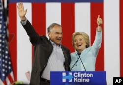 Democratic U.S. vice presidential candidate Senator Tim Kaine of Virginia waves with his presidential running mate Hillary Clinton at a campaign rally in Miami, Florida, U.S. July 23, 2016.