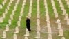 FILE - An Iraqi Kurd resident visits the cemetery for victims of the 1988 chemical attack in the Kurdish town of Halabja, near Sulaimaniya, 260 km (160 miles) northeast of Baghdad, March 16, 2014.