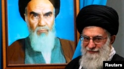 Supreme Leader Ali Khamenei, shown here with a painting of his predecessor, the late Ayatollah Khomenei, is the ultimate power in Iran.