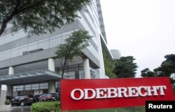 Federal police cars are parked in front of the headquarters of Odebrecht, a large private Brazilian construction firm, in Sao Paulo, Brazil, June 19, 2015.