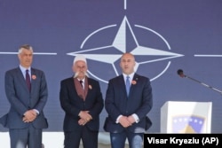 KOSOVO -- Kosovar Prime Minister Ramush Haradinaj, right, Rifat Jashari family member of the Jashari family and Kosovar President Hashim Thaci, left, attend the 20th anniversary of the NATO bombing in the village of Glogjan, March 24, 2019