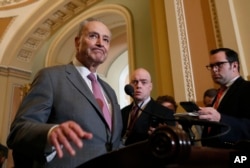 FILE - Senate Democratic Minority Leader Chuck Schumer (New York), left, pauses while speaking during a media availability on Capitol Hill, May 8, 2018, in Washington.
