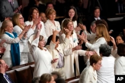 Members of Congress cheer after President Donald Trump acknowledges more women in Congress during his State of the Union address to a joint session of Congress on Capitol Hill in Washington, Tuesday, Feb. 5, 2019. (AP Photo/Carolyn Kaster)