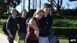 Students react following a shooting at Marjory Stoneman Douglas High School in Parkland, Florida, a city about 50 miles (80 kilometers) north of Miami, Florida, Feb. 14, 2018.