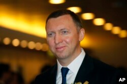 FILE - Oleg Deripaska CEO of UC Rusal smiles at the Hong Kong Stock Exchange during the debut of the company in Hong Kong, Jan. 27, 2010.