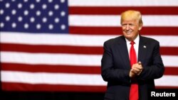 U.S. President Donald Trump takes the stage for a rally at the U.S. Cellular Center in Cedar Rapids, Iowa, U.S.