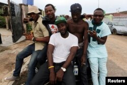 Members of the Fire Nation Blowing Purple Cloud hip hop crew pose for a picture outside recording studio in the Festac district of Lagos, Nigeria, May 17, 2016.