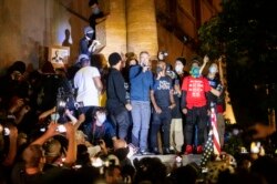 Portland Mayor Ted Wheeler speaks to Black Lives Matter protesters on Wednesday, July 22, 2020, in Portland, Ore.