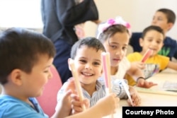 Children do some coloring at the Selam Orphanage. (M. Qarra)