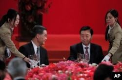 Hong Kong Chief Executive Leung Chun-ying (l) looks at Zhang Dejiang (r) chairman of China's National People's Congress, during a banquet in Hong Kong on May 18, 2016.