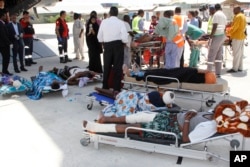 Critically wounded people wait to be moved into a waiting Turkish plane to be airlifted for treatment in Turkey, in Mogadishu, Somalia, Oct, 16, 2017.