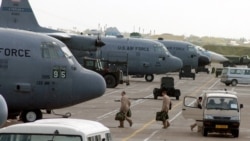 C-130 Hercules aircrew members board their aircraft for an Operation Enduring Freedom mission at Karshi-Khanabad Air Base, Uzbekistan, on April 19, 2005. (U.S. Air Force Photo)