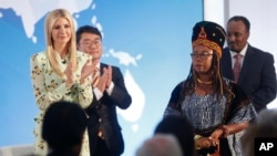 Ivanka Trump, left, the daughter and assistant to President Donald Trump, applauds after listening to a speech made by Francisca Awah Mbuli, right, from Cameroon and survivor of human trafficking, during an event to announce the 2018 Trafficking in Person