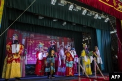 Chiu Chow Opera performers sing on stage as part of the Hungry Ghost Festival in Hong Kong on September 4, 2018.