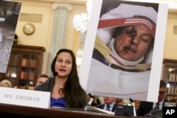 FILE - Stephanie Erdman, an Air Force 1st lieutenant, describes her experience when she was injured by metal fragments from a defective airbag made by Takata of Japan as she testifies on Capitol Hill in Washington, Nov. 20, 2014.